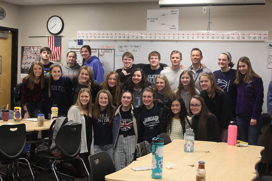 All gathered together, FCA members smile to take a group photo with Rob Collins.
