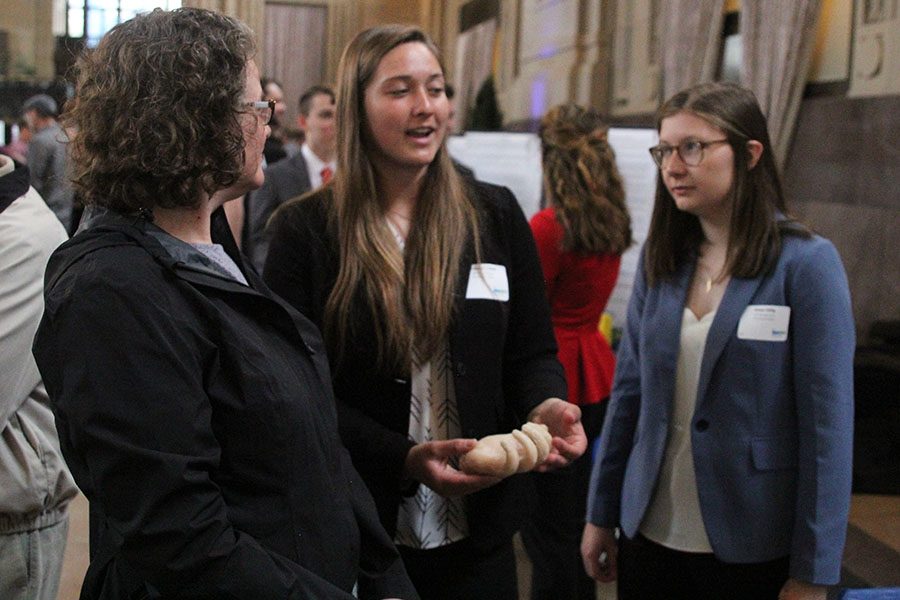 Holding the prosthetic hand, senior McKenna Elliott walks a viewer through the process of creating her and seniors Katya Gillig and Collin Prosser’s project. Their project seeks to allow prosthetic limb users to paddle board efficiently.