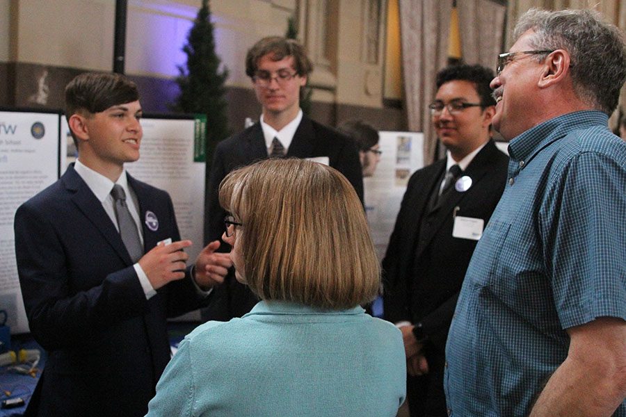 After telling a joke, senior Drew Lewis continues giving his presentation.