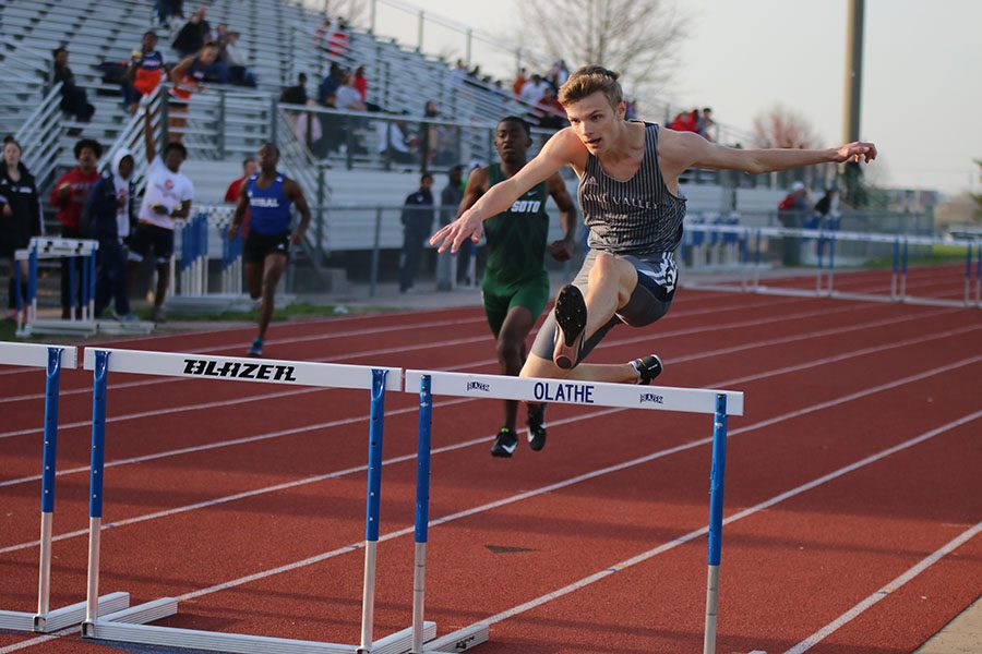 Jumping over the hurdle, sophomore Leif Campbell competes in the 110 meter hurdles.