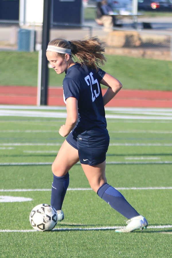 After stopping the ball, sophomore Emma Schieber looks for an open teammate.