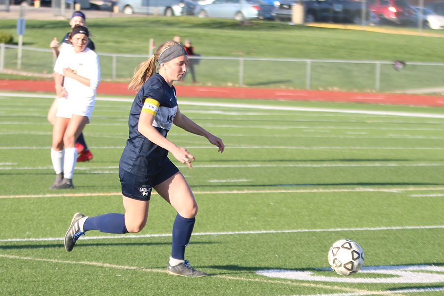 Making her way towards the ball, junior Emerson Kaiser turns back upfield.
