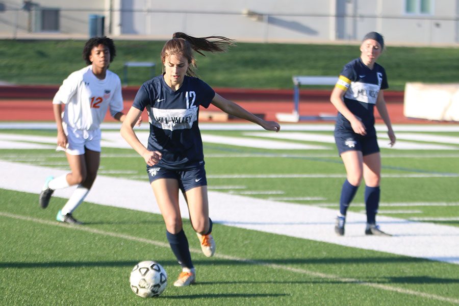 After getting the ball back, sophomore Avery Rutkowski dribbles the ball back upfield.
