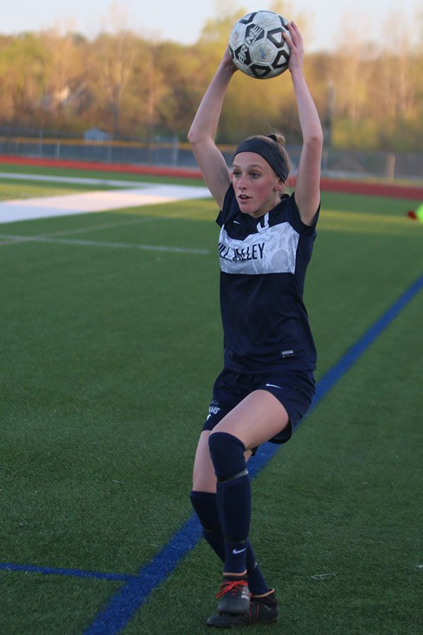 With the ball over her head, junior Annie Hoog throws the ball back in to her teammates.

