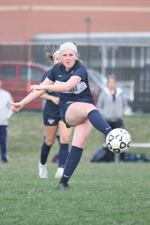 Kicking the ball sophomore Paige Goetsch, drills it away from her. 