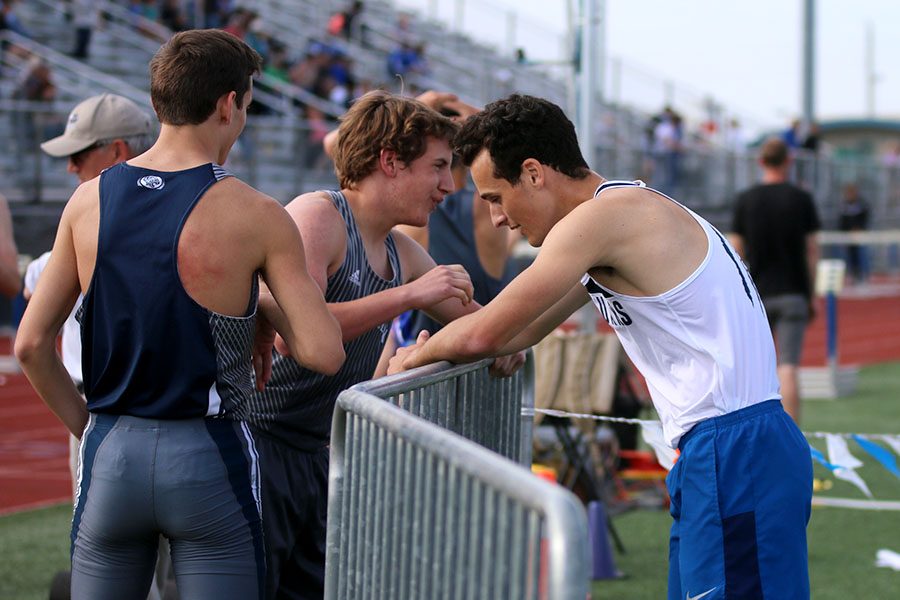 Gathering together after the 4x800 meter relay, junior Darius Hightower, freshman Kris Twigg and senior Matthew Turner discuss how the race went. The team placed fourth in the event. 