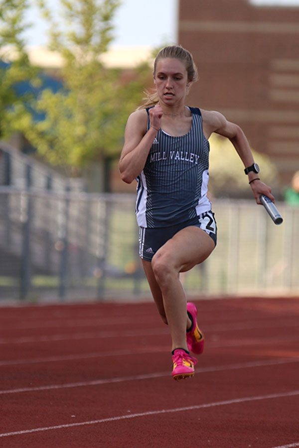 Finishing off the 4x100 meter relay, senior Aniston Cumbie sprints towards the finish line. The team finished fifth in the event.