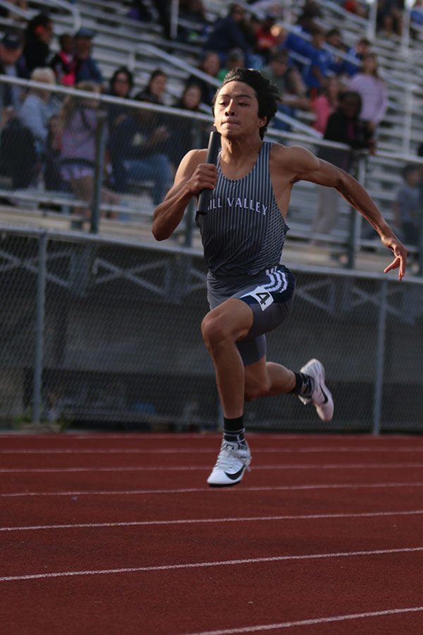 Bounding through the air, junior Nico Gatapia sprints to finish the 4x100 meter relay. The team finished seventh in the event.