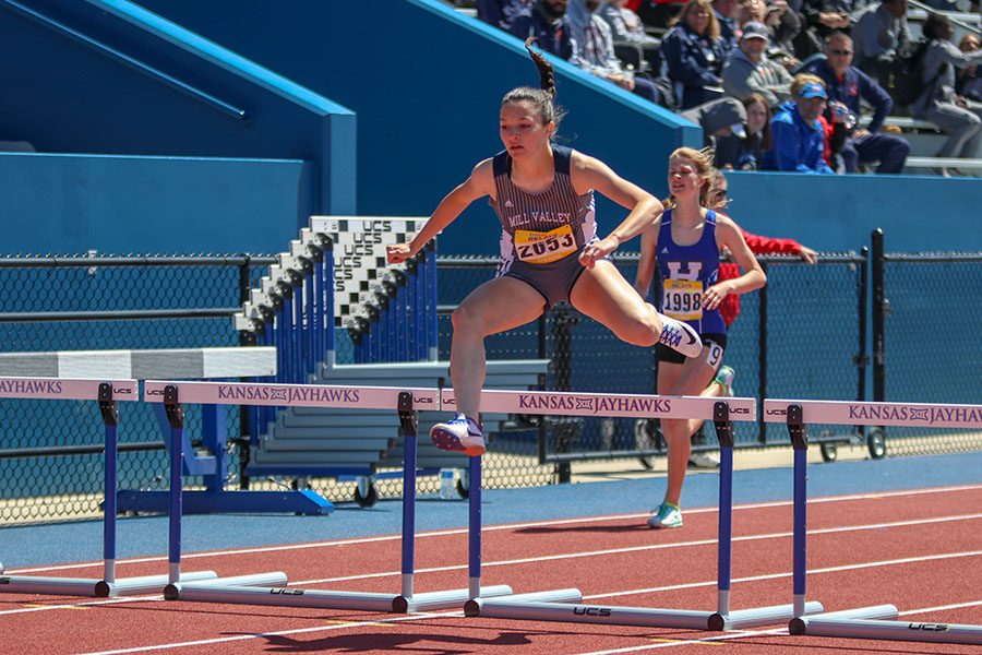 Jumping over the last set of hurdles, freshman Quincey Hubert competes in the 300m hurdles. Hubert placed 4th in her heat. 