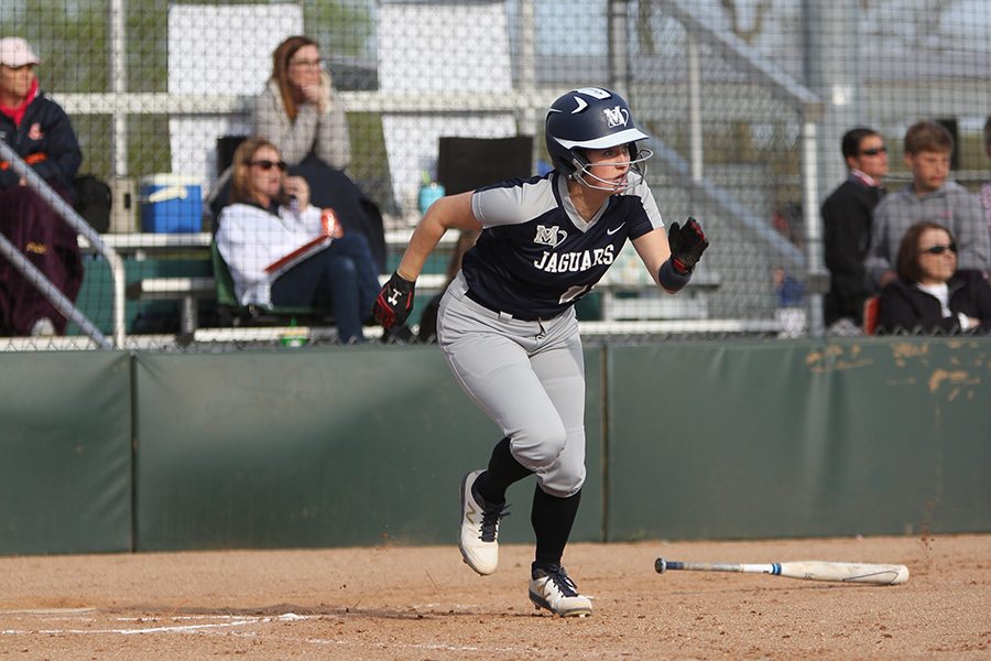 After a hitting a single to the outfield, junior Paige Oliver runs for first base. 