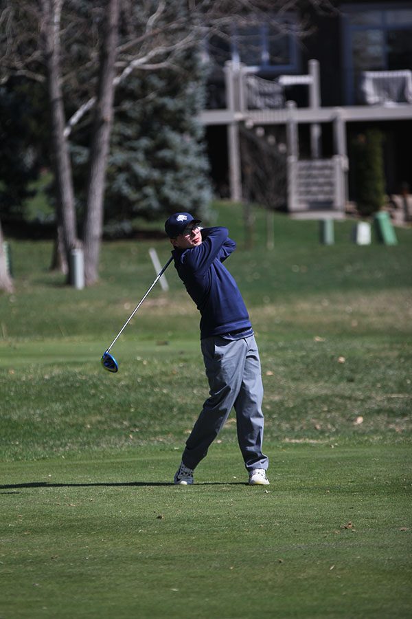 Looking down the fairway, senior Jack Matchette tees off on hole 16.