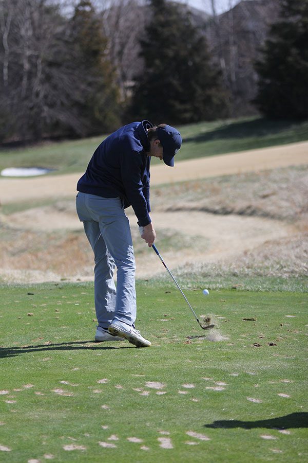 Keeping his eye on the ball,  senior Blake Aerni aims his ball onto the green on hole 14 on Monday, April 1.