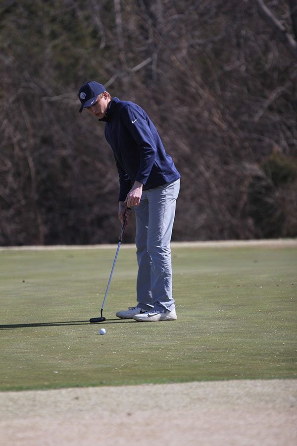 On his 7th hole of the day, senior Blake Aerni puts on hole 14.