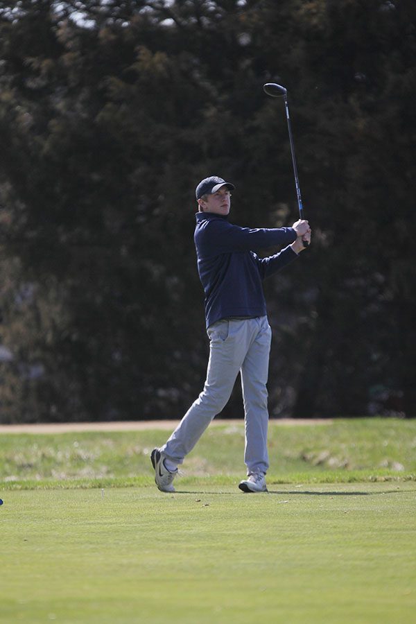 Watching his shot, senior Nick Davie tees off on hole 12 to finish 29th overall in the meet.