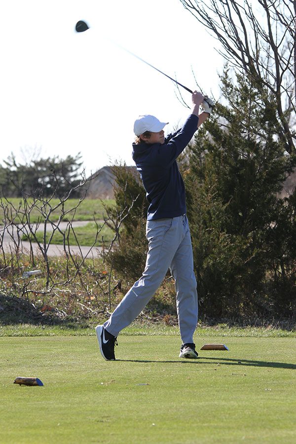 Teeing off at hole 11, senior  Tanner Moore follows through with his swing and finishes 16th overall.