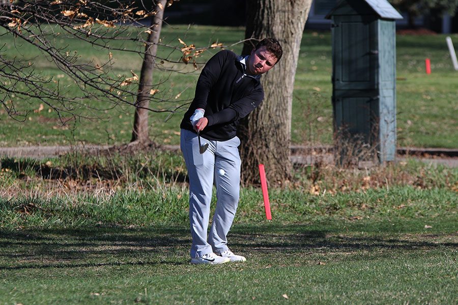 Controlling his swing, junior Charlie Flick lands his ball on the green while getting it out of the rough during hole 15 to place 30 at the BVNW Invitational.