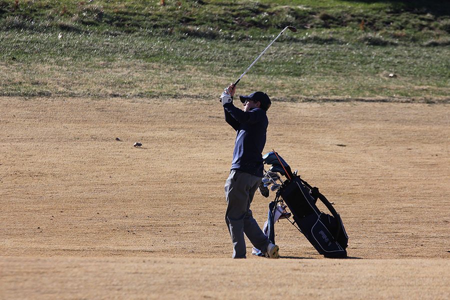 Shooting for the green, senior Jack Matchette competes on hole 6 at the Lions Gate golf course on April 1st.