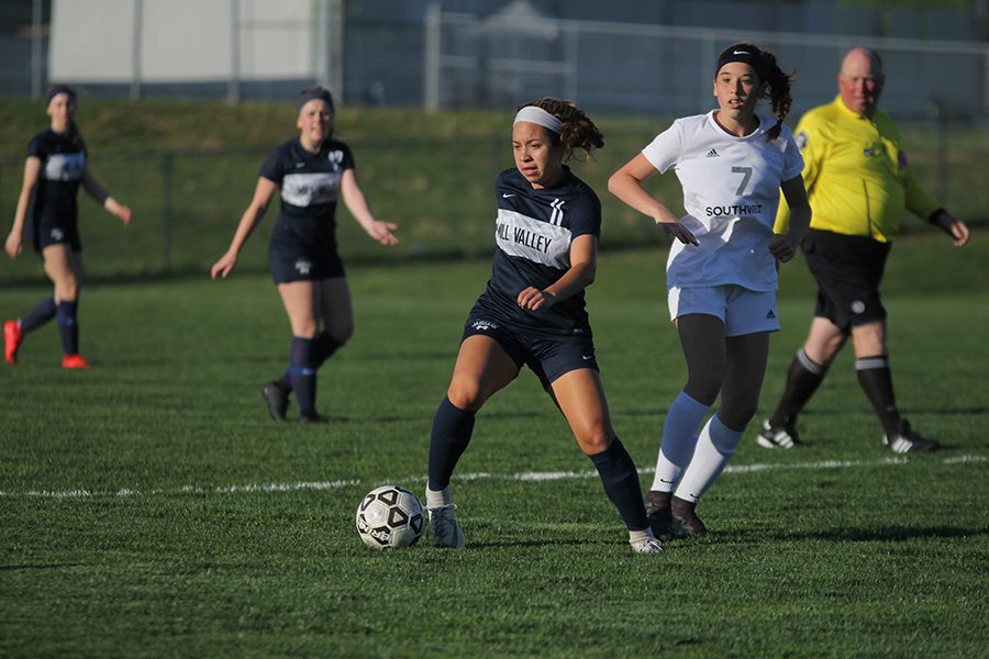 Eyes up, junior midfielder Cristina Talavera looks around for a pass to a teammate while maintaining control of the ball