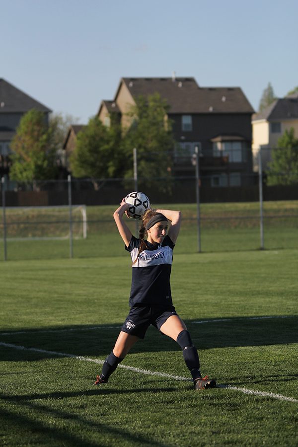 Retreiving the ball from out-of-bounds, junior defender Annie Hoog looks for a teammate downfield.