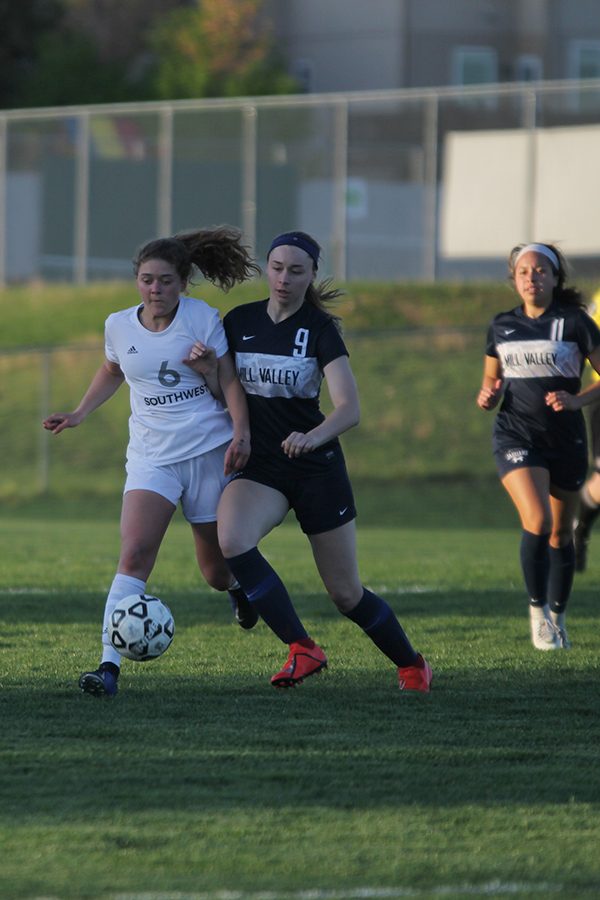 Within the midfield, sophomore Mia Colletti fights to gain possession of the ball at a home game on April 25th.