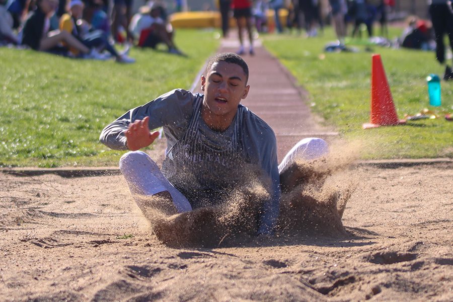 With his eyes closed, freshman Adrian Dimond competes in the long jump.