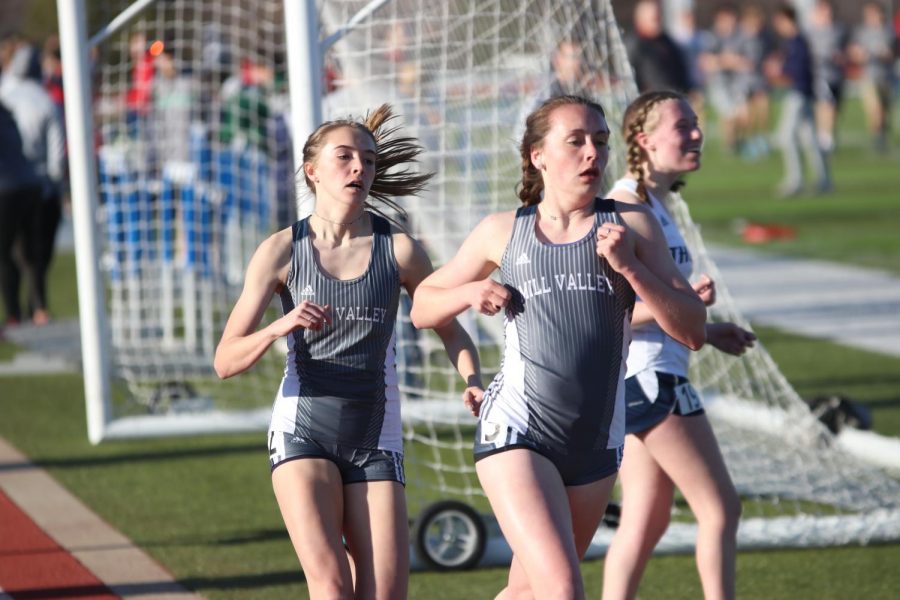 During the 800 meter dash on Friday, April 5, senior Delaney Kemp competes with her teammate junior Molly Haymaker. Kemp, like other girls varsity athletes at Mill Valley, was forced to choose between soccer and running during her freshman year.