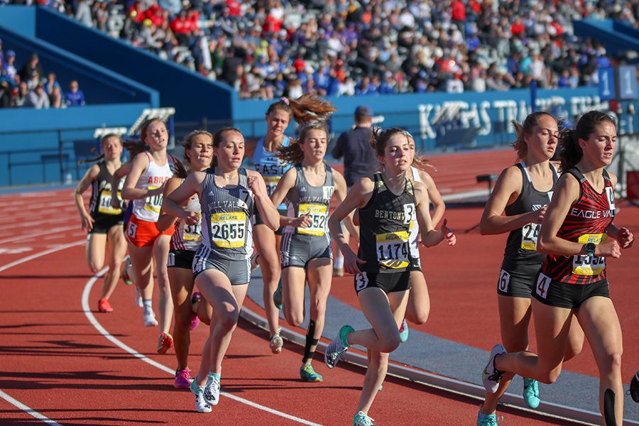 Running on the outside line, senior Delaney Kemp competes in the 800 meter run. 