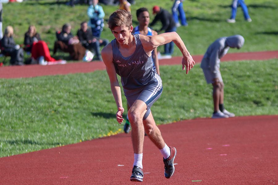 Focusing on the runway, junior Anthony Runk makes his approach in the high jump.  