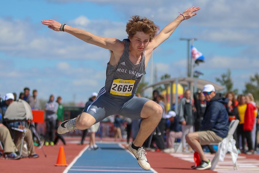 Spreading his arms apart, senior Steven Colling competes in the triple jump competition at KU Relays on Friday, April, 19. Colling finished 18th. 