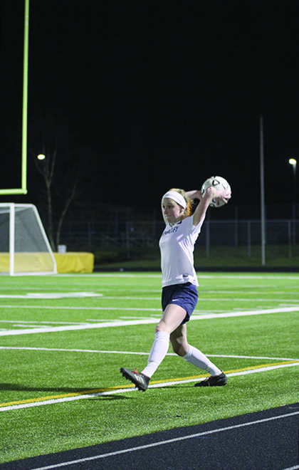 Junior Annie Hoog throws the ball back in bounds at the girls soccer game on Thursday, April 4. I choose soccer because I knew I could have a future with college soccer, Hoog said.