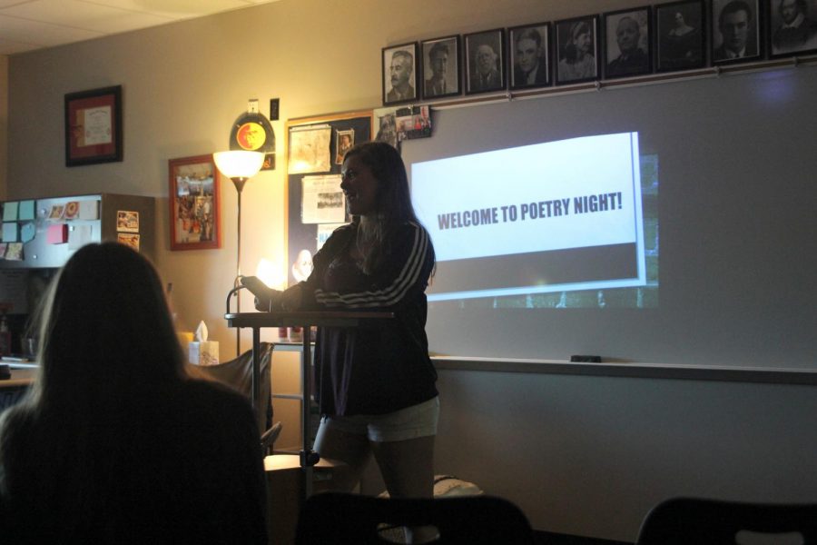 Standing in front of the crowd, senior Deanna Newman reads her poem. 