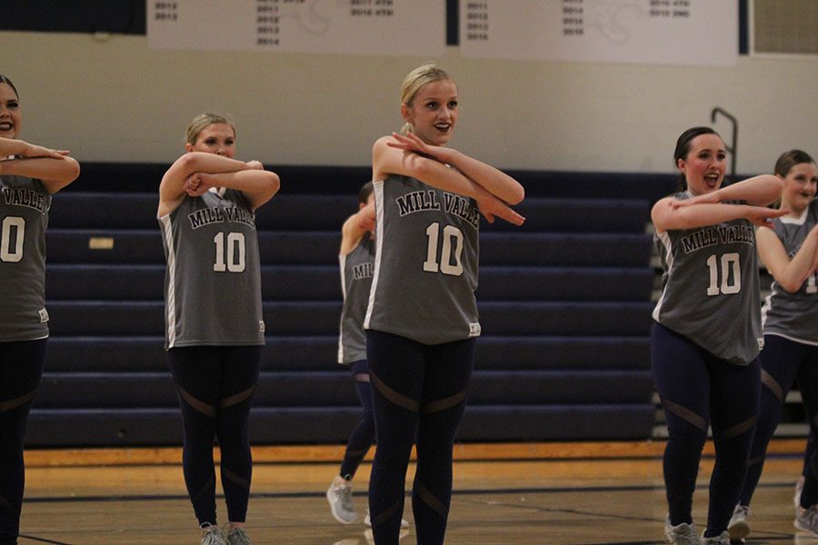 Leading the team, senior Bella Line performs alongside senior Eve Steinle and sophomore Jenna Haase. 