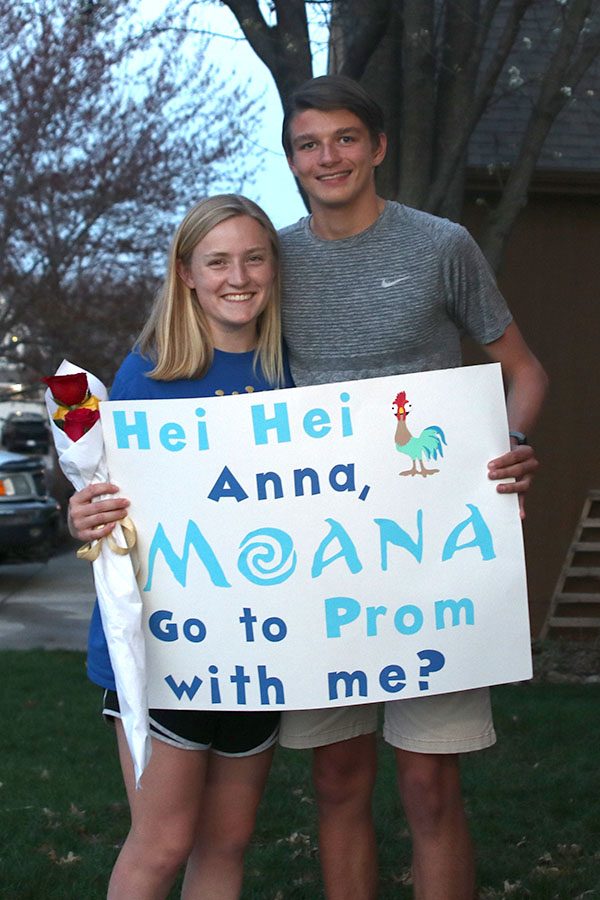 After prom-posing to junior Anna Ricker, junior Nathan Greenfield holds flowers and a handmade sign.

