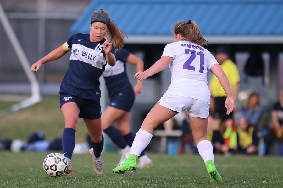 Dribbling the ball down the field, senior Shyanne Best keeps the ball out of reach from the defender.