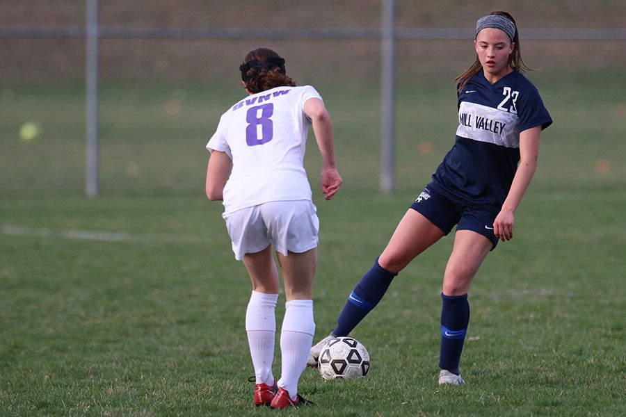 Trying to cross the ball, junior Katherine Weigel ignores a BVNW player.