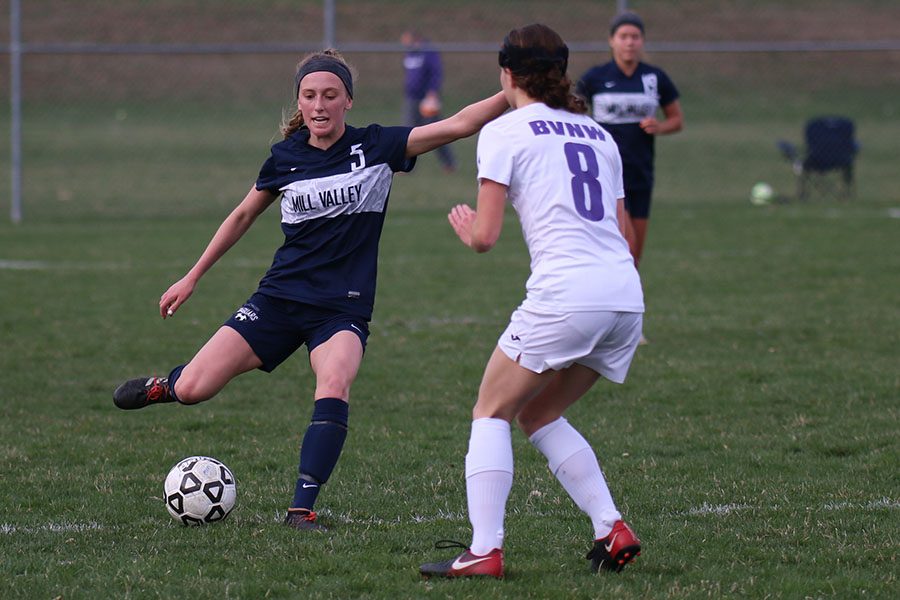 Running toward the ball, junior Annie Hoog rushes past a BVNW defender.