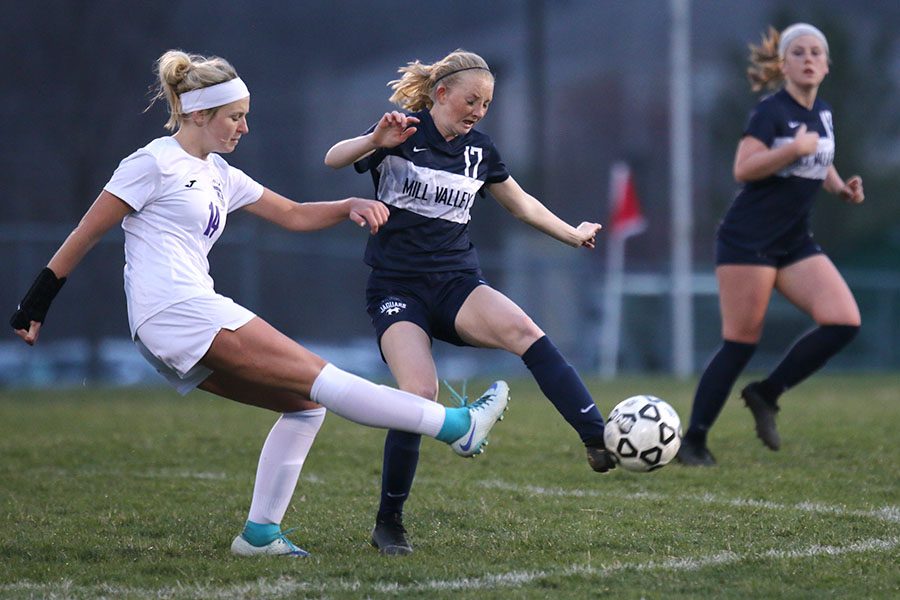 At the end of the first half, senior Kendra Bross tries to maintain possession of the ball.