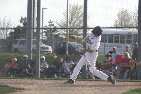 Swinging to hit the ball, sophomore Lucas Pringle hits the ball out to the right field on Tuesday, April 16. 
