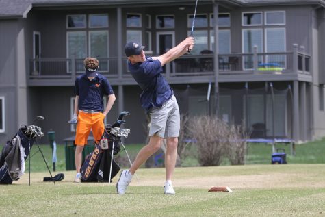 After hitting the golfball, senior Nick Davie watches it travel.