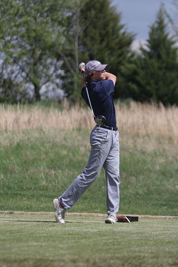 Turning forward, senior Tanner Moore watches his ball travel down the freeway.