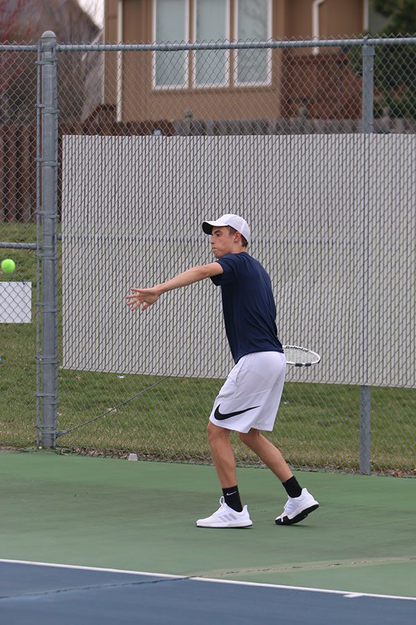 Taking a step towards the ball, junior Josh Glunt looks to make contact with the ball.