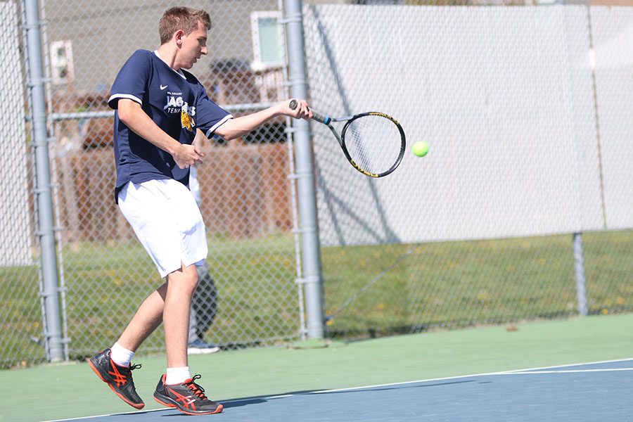 In his double match with senior Andrew Lewis, sophomore John Scarpa returns the ball off a serve.