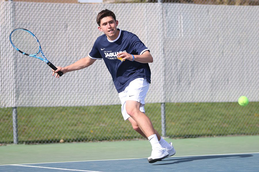 Keeping an eye on the ball, sophomore Keaton Verdict sprints along the baseline. 