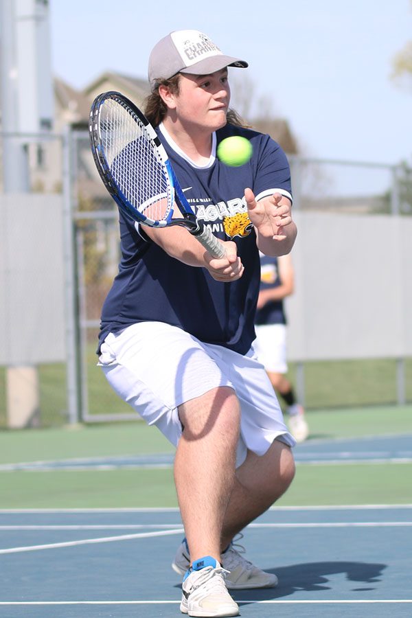  Hitting a volley, junior Charlie Schwartzkopf looks to pop the ball just over the net.