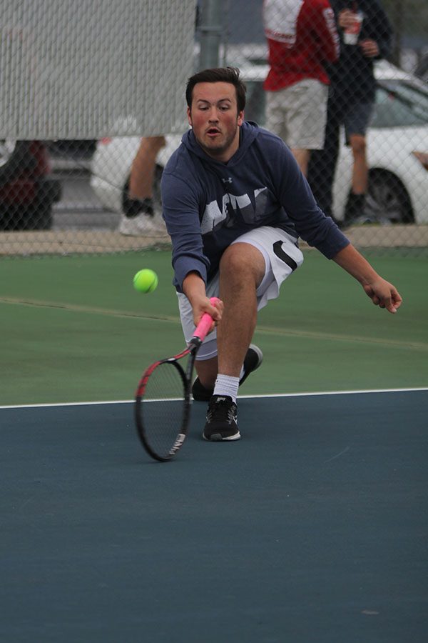 Lunging forward, senior Jacob Hoffman saves the ball.