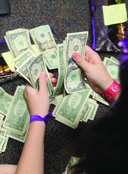 Sorting money, senior Kate Backes helps count the amount brought in from on-site fundraisers.
This year, Relay for Life of Jaguar Nation raised a
total amount of $112,336.75. 
