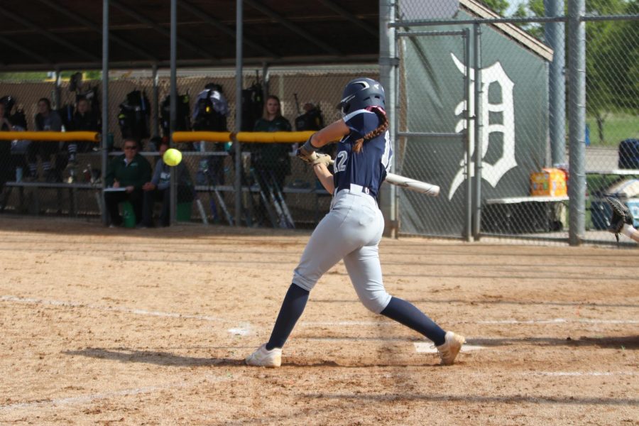 Hitting the ball, junior Lauren Florez aims towards the outfield. 