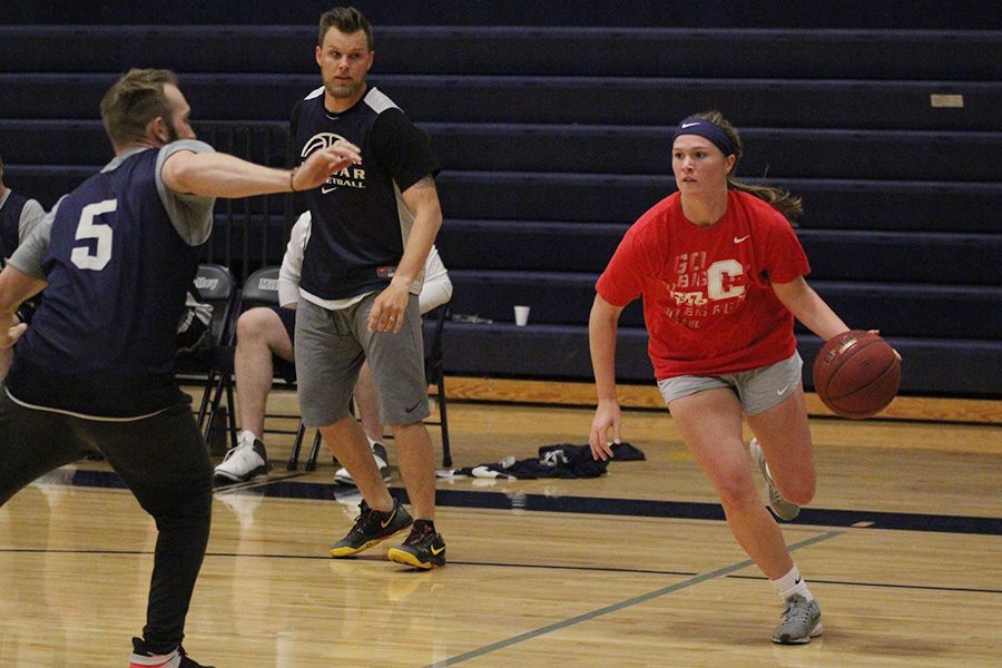 Running past faculty members, senior Claire Kaifes dribbles the ball on Tuesday, April 30.