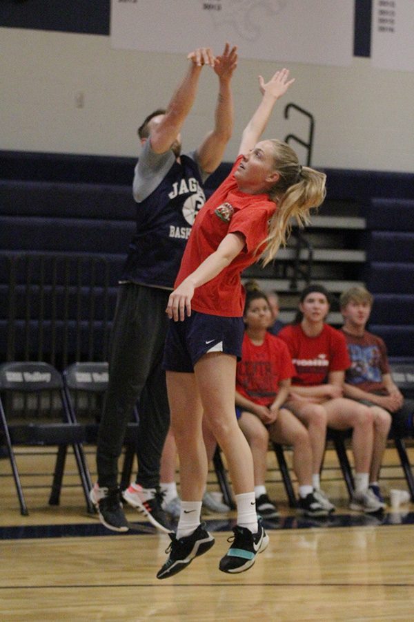 Jumping, senior Lexi Ballard attempts to block the ball during the Student vs. Faculty game on Tuesday, April 30.