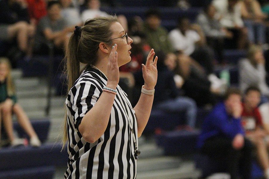 As a referee in the Student vs. Faculty game, science teacher Jessica Long calls a foul on Tuesday, April 30.